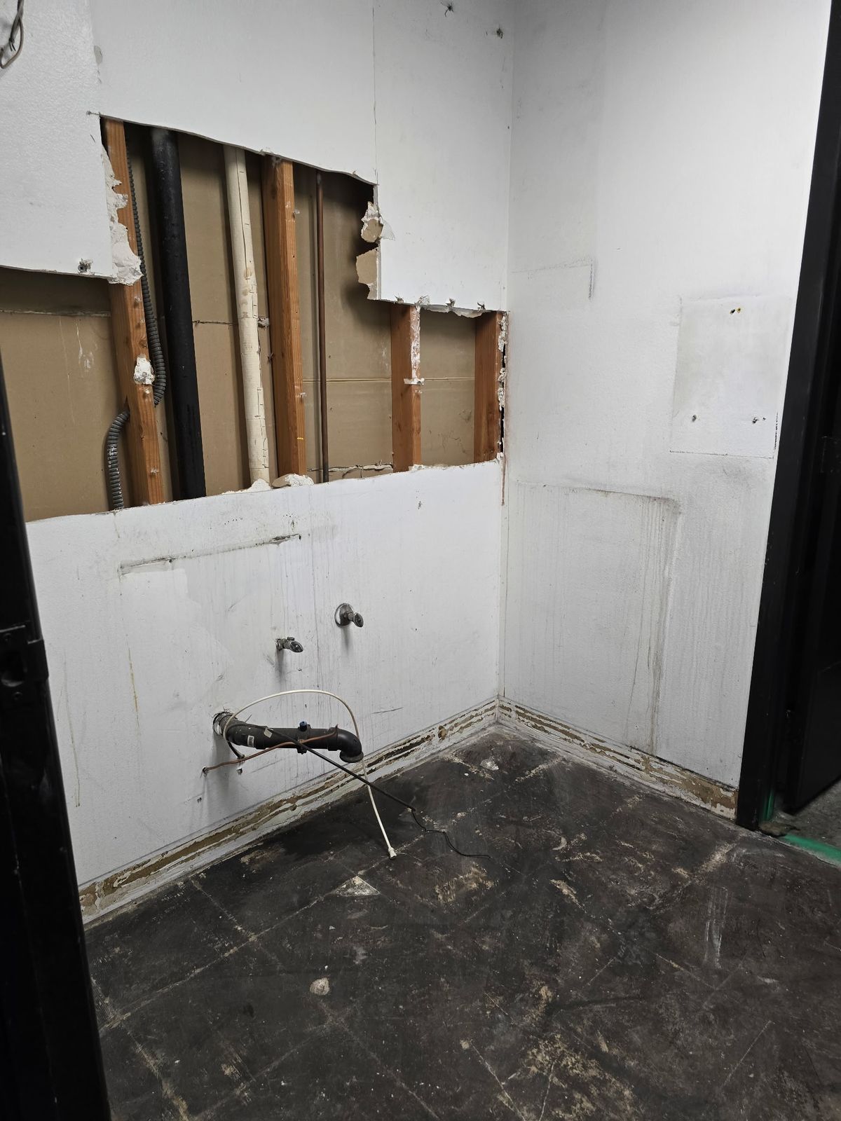 Bathroom drywall removed exposing plumbing