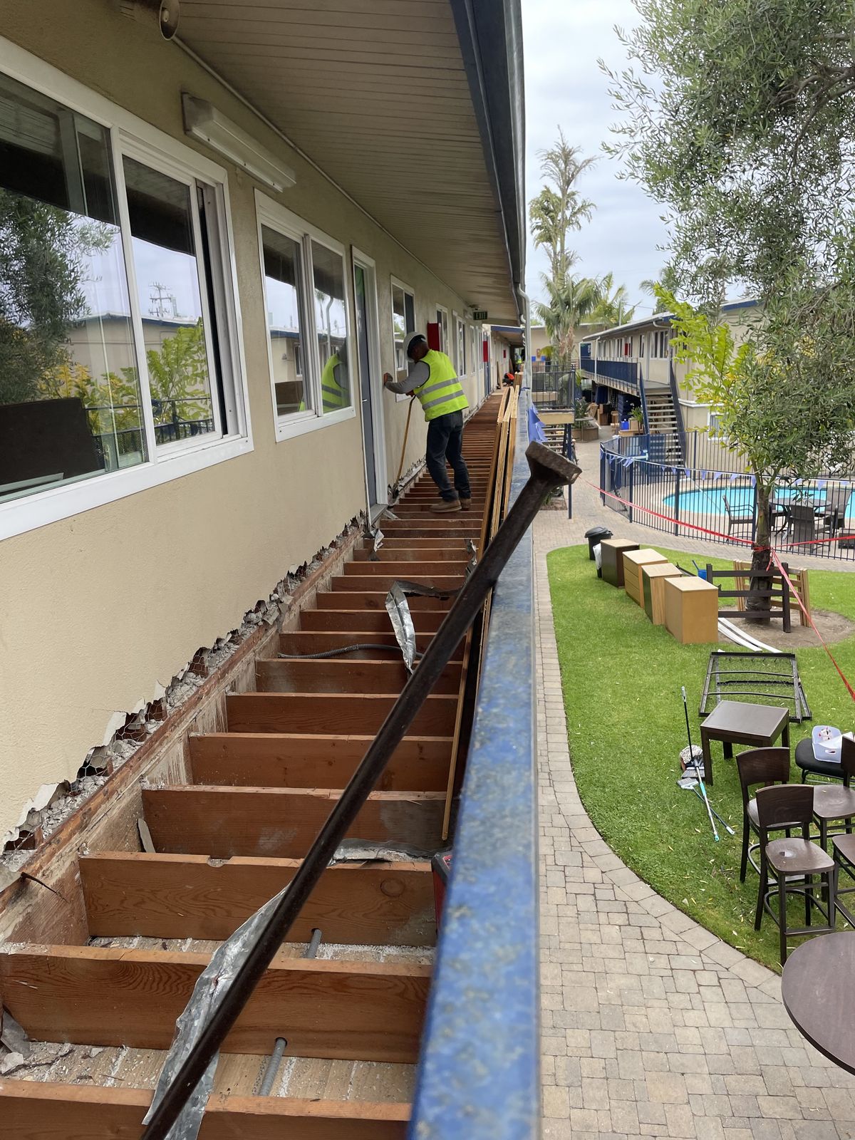 Crew lifting structural beam during commercial demolition