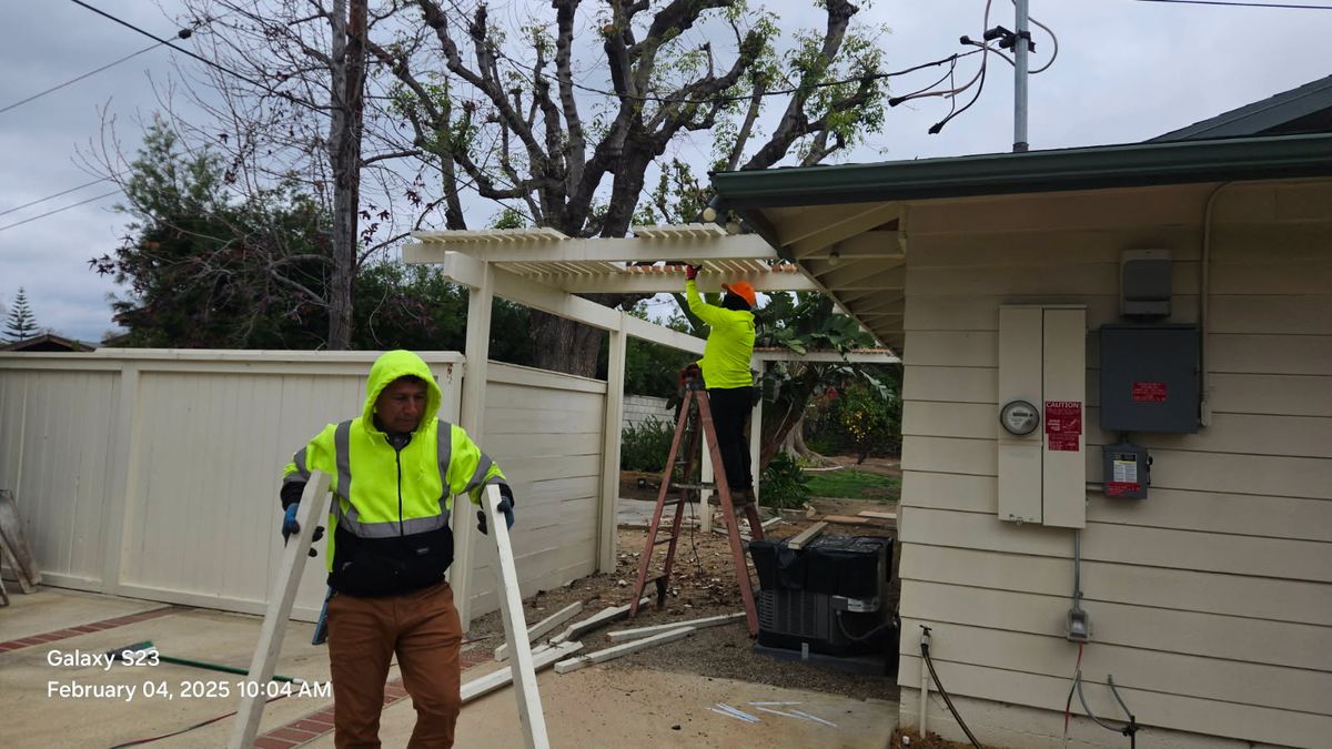 Crew dismantling backyard carport and patio cover