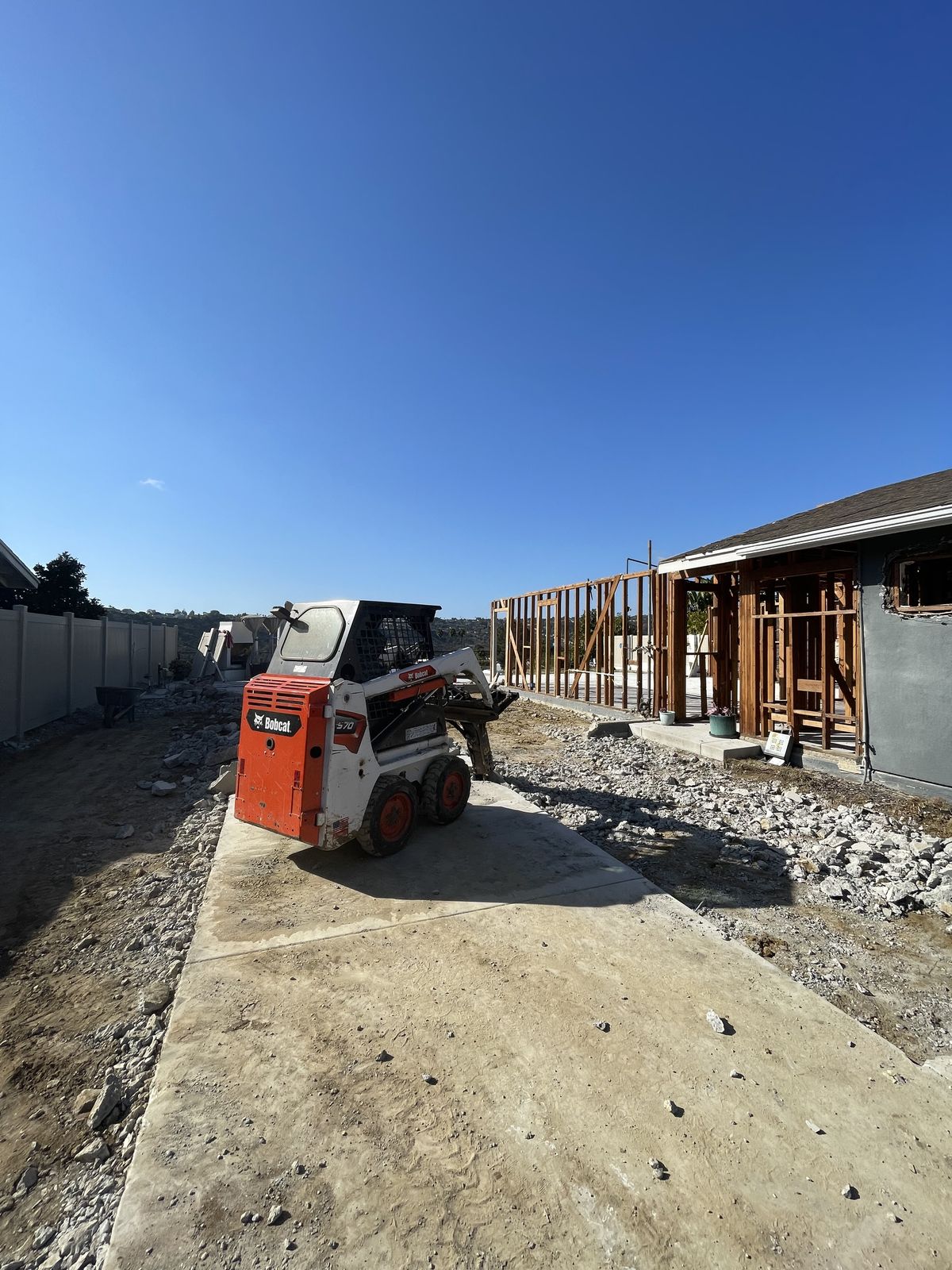 Bobcat skid steer working on structure teardown